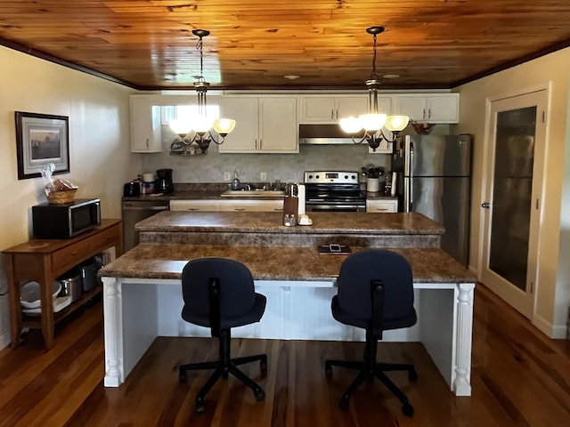 kitchen featuring an inviting chandelier, a center island with sink, hanging light fixtures, appliances with stainless steel finishes, and white cabinets