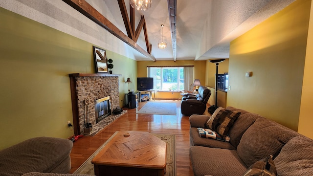 living room with a fireplace, wood-type flooring, and lofted ceiling with beams