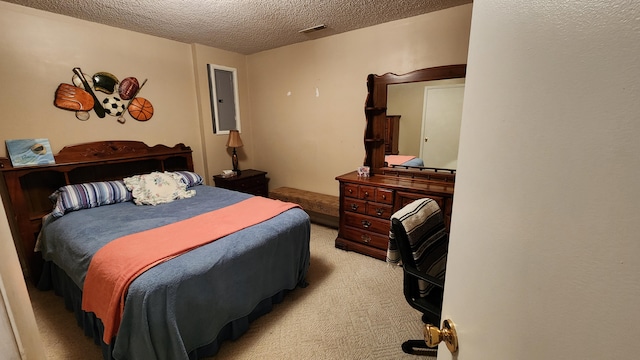 carpeted bedroom with a textured ceiling