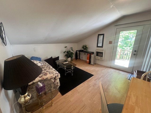 living room with radiator heating unit, lofted ceiling, and light hardwood / wood-style floors