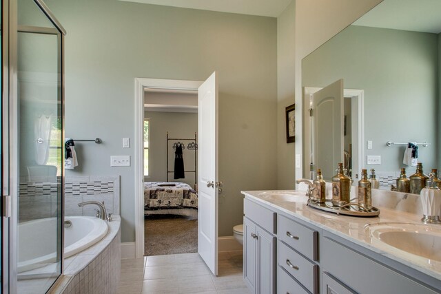 full bathroom with double vanity, shower with separate bathtub, tile patterned floors, and toilet