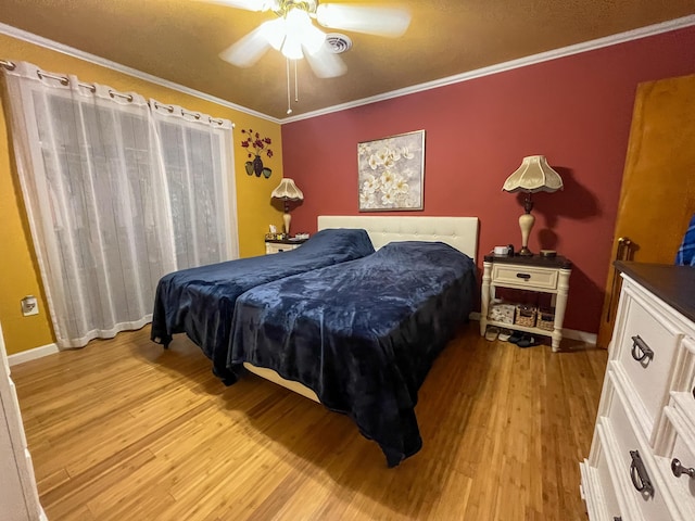 bedroom with baseboards, light wood-type flooring, ornamental molding, and ceiling fan