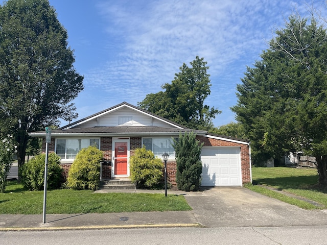 ranch-style home with an attached garage, concrete driveway, a front yard, and brick siding