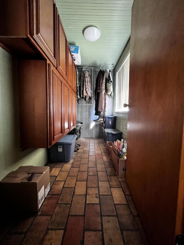 mudroom featuring brick floor