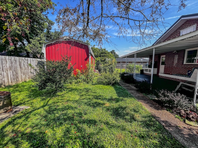 view of yard featuring fence and an outbuilding