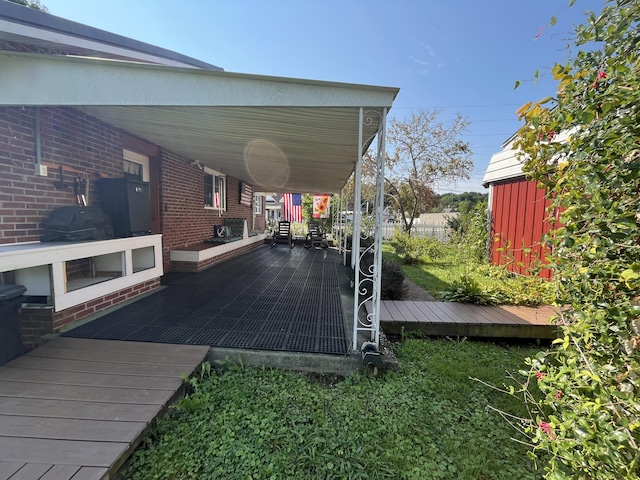 wooden deck featuring area for grilling