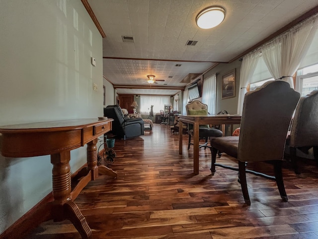 dining room with ornamental molding, dark wood finished floors, and visible vents