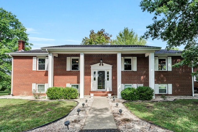 raised ranch with a front lawn