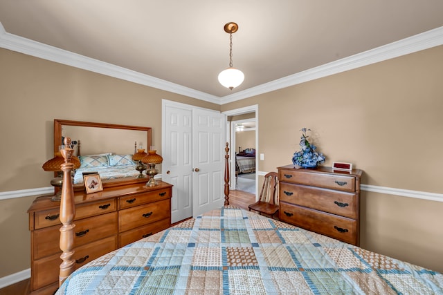 bedroom with hardwood / wood-style flooring, a closet, and crown molding