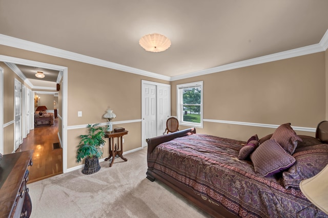 bedroom with crown molding and light colored carpet