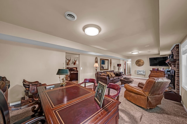 interior space with a fireplace, carpet, and brick wall