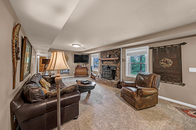 living room featuring carpet flooring, a brick fireplace, and brick wall