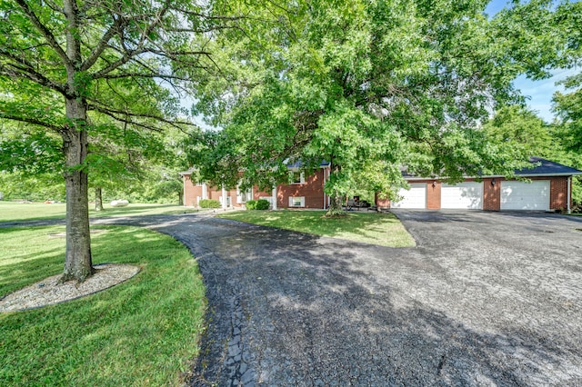 view of front facade with a garage and a front lawn