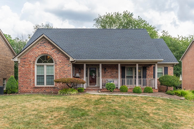 view of front facade featuring a front yard, a porch, and central air condition unit