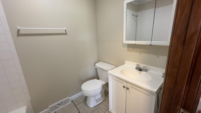 bathroom with vanity, tile patterned floors, toilet, and walk in shower