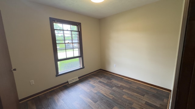 spare room featuring dark hardwood / wood-style floors