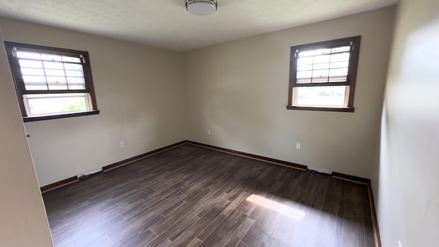 unfurnished room featuring dark hardwood / wood-style flooring