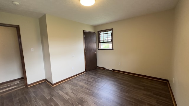 unfurnished bedroom featuring dark hardwood / wood-style floors and a closet