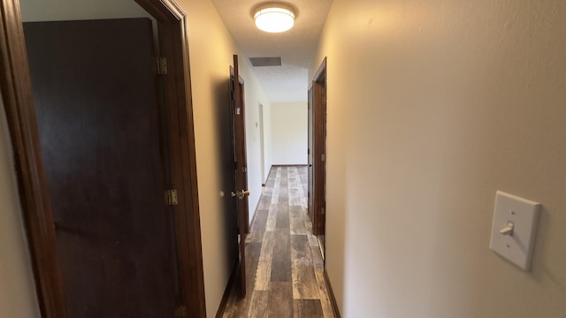 corridor with dark wood-type flooring