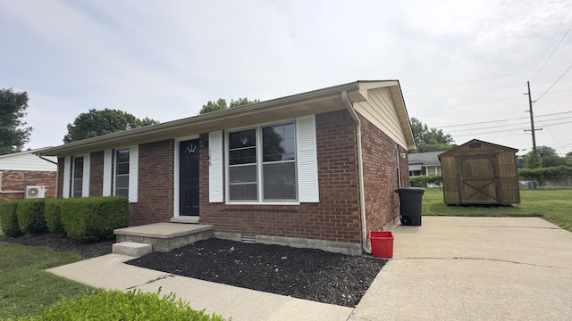 view of front of property with a storage shed and a front lawn