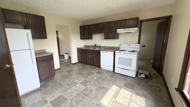 kitchen with sink, white appliances, dark brown cabinets, and a textured ceiling