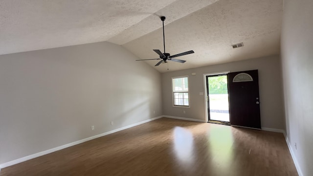 entrance foyer with visible vents, baseboards, ceiling fan, vaulted ceiling, and wood finished floors