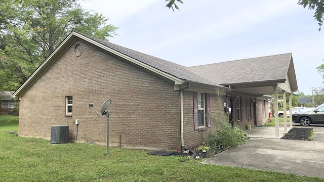 view of property exterior featuring a shingled roof, brick siding, central air condition unit, and a lawn
