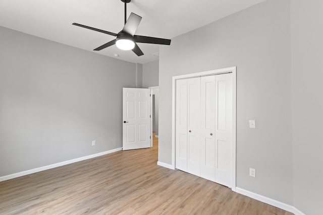 unfurnished bedroom featuring a closet, ceiling fan, and light hardwood / wood-style flooring