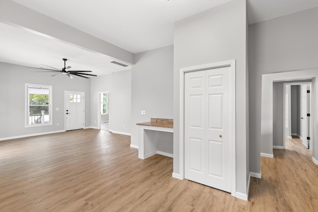 unfurnished living room with light hardwood / wood-style flooring and ceiling fan