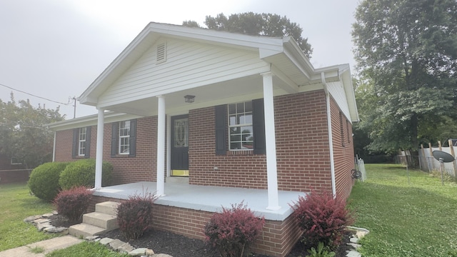 view of front of home featuring a porch and a front yard