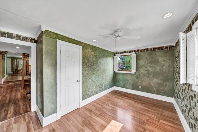 unfurnished room featuring ornamental molding, hardwood / wood-style floors, and ceiling fan