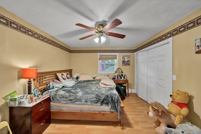 bedroom with a closet, ceiling fan, and light wood-type flooring