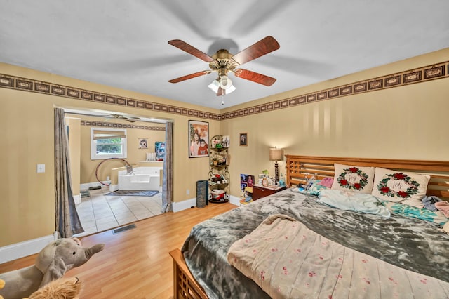 bedroom with light hardwood / wood-style floors and ceiling fan