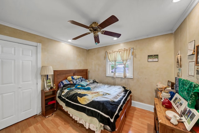 bedroom featuring crown molding, ceiling fan, wood-type flooring, and a closet