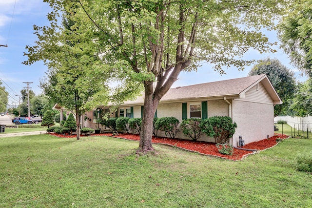 ranch-style home with a front lawn