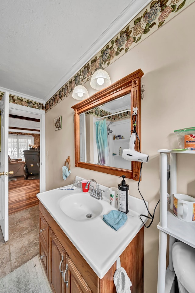 bathroom featuring vanity, tile patterned floors, and crown molding