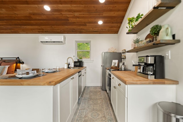 kitchen with an AC wall unit, white cabinets, wooden ceiling, butcher block countertops, and sink