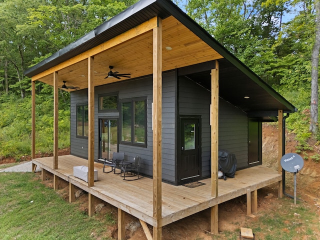 wooden deck featuring ceiling fan