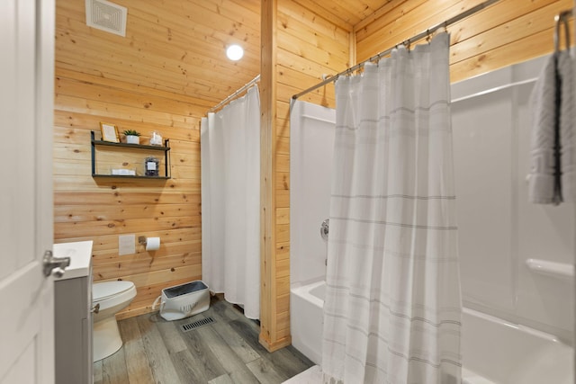 bathroom featuring wood walls, toilet, wooden ceiling, shower / tub combo, and wood-type flooring