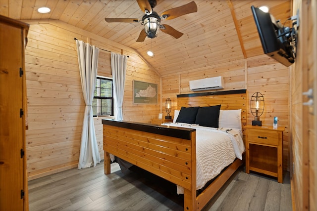 bedroom with wood walls, vaulted ceiling, wood ceiling, and wood finished floors