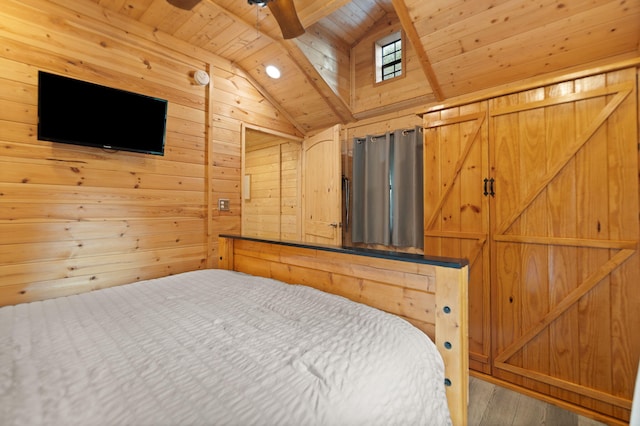 bedroom with vaulted ceiling with beams, wooden walls, wood ceiling, ceiling fan, and wood-type flooring