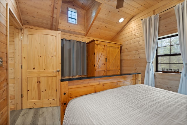 bedroom with wooden ceiling, wood walls, vaulted ceiling, and wood finished floors