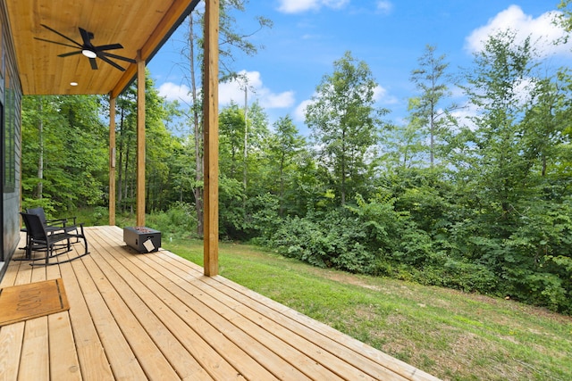 deck featuring a yard and ceiling fan