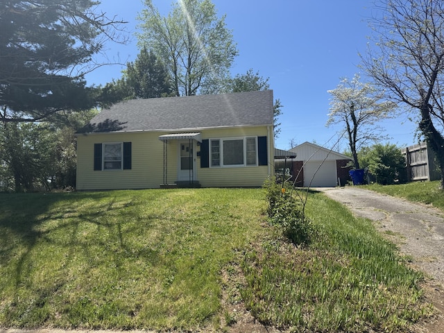 view of front of home featuring an attached garage, driveway, a front yard, and roof with shingles
