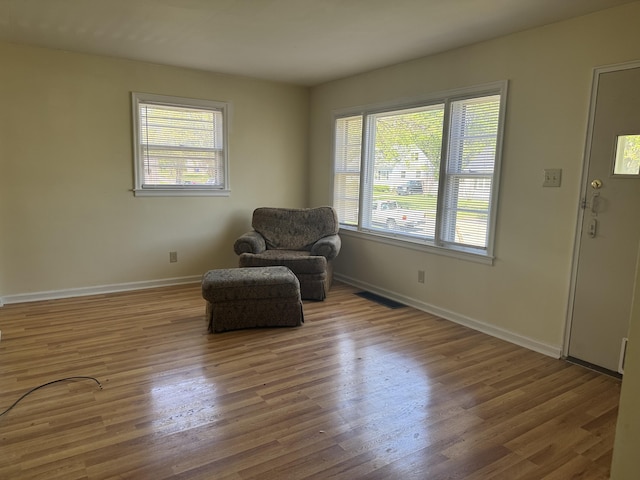 sitting room with plenty of natural light, visible vents, and baseboards