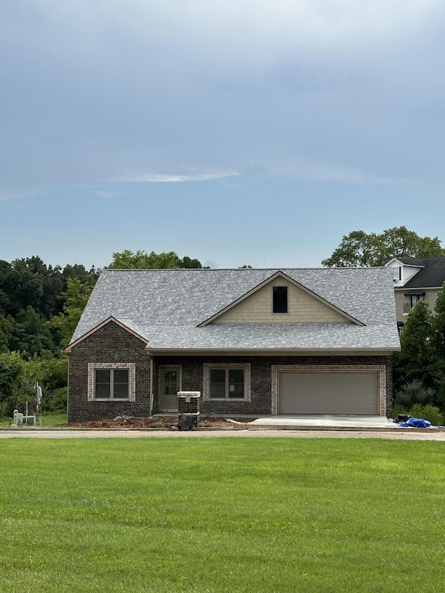 view of front of house featuring an attached garage, brick siding, roof with shingles, and a front yard