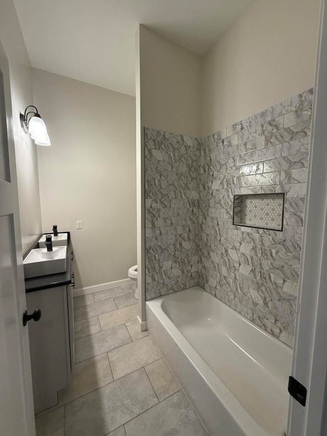 full bath featuring baseboards, vanity, toilet, and tile patterned floors