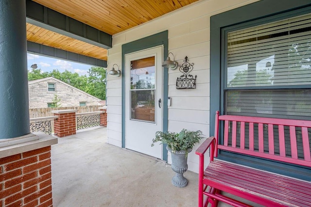 view of exterior entry with a porch