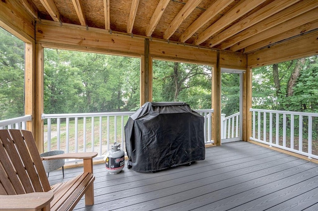 wooden deck featuring a grill