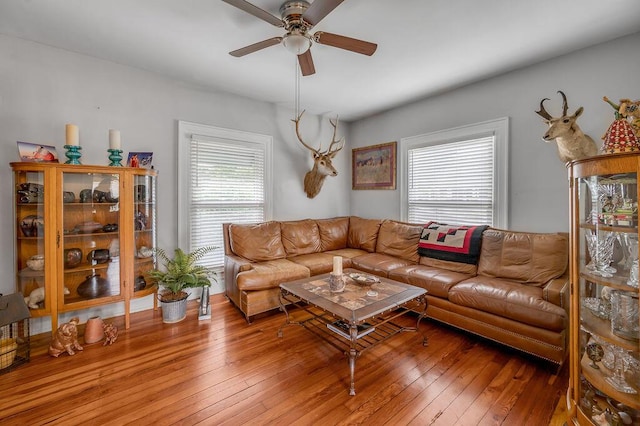 living room featuring plenty of natural light, a ceiling fan, and wood finished floors